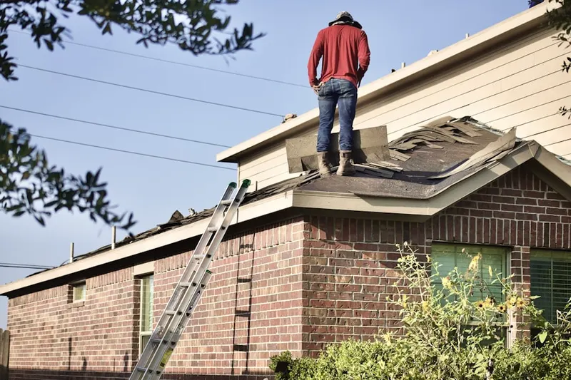 Professional roofer working on a residential roof in Virgil Village